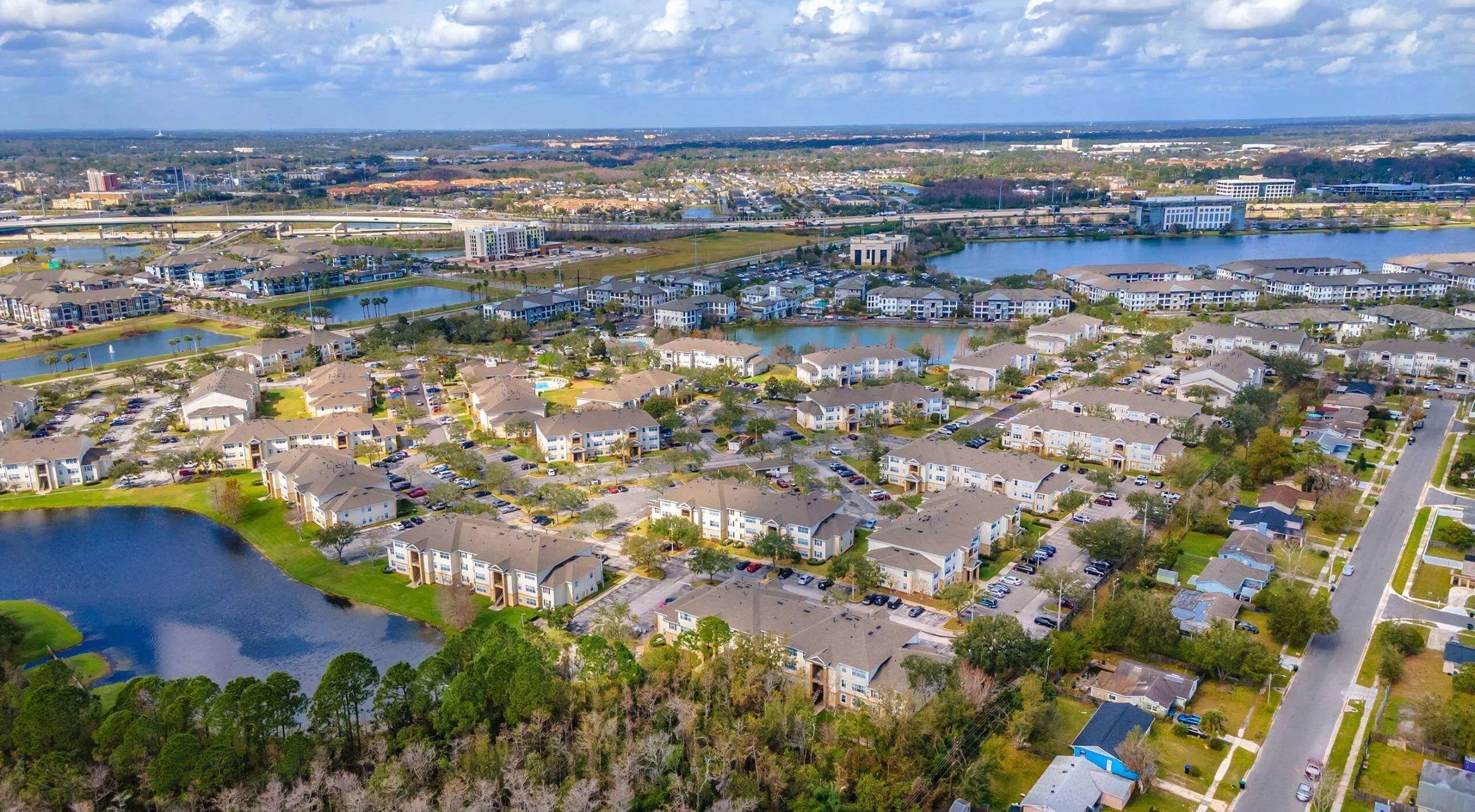 Aerial image of The Villages on Millenia showing greenery, waterways and roads surrounding development